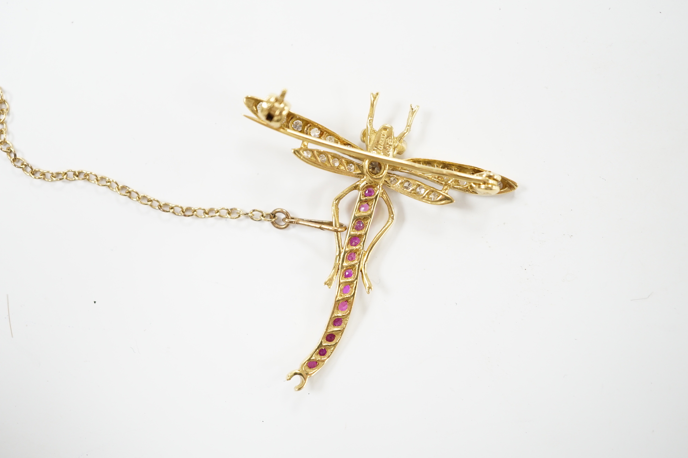 A modern 18ct gold, ruby, emerald and diamond cluster set dragonfly brooch, 40mm, gross weight 4.8 grams.